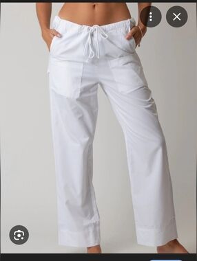 white, wide-leg utility pants featuring a drawstring waistband and patch pockets